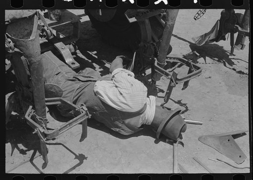 Untitled photo, possibly related to: Adjusting plow points on tractor-drawn planter, large farm near Ralls