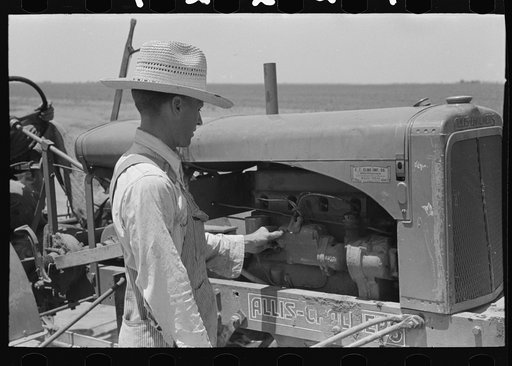 Untitled photo, possibly related to: Day laborer cranking tractor on farm near Ralls, Texas