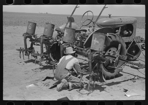 Untitled photo, possibly related to: Day laborer adjusting plow points on tractor-drawn planter, near Ralls, Texas