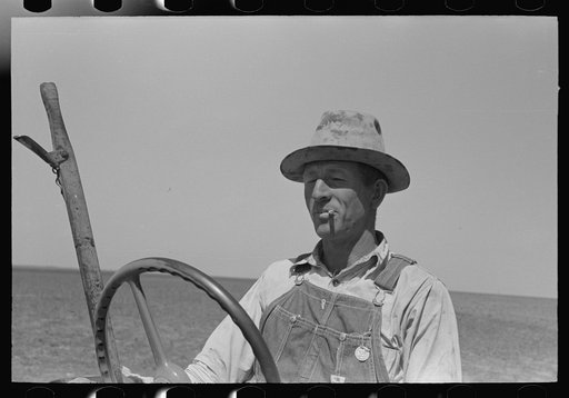 Untitled photo, possibly related to: Day laborer adjusting plow points on tractor-drawn planter, near Ralls, Texas