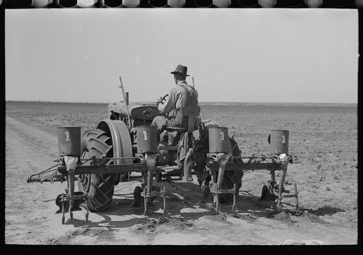Tractor with four-row planter, large farm near Ralls, Texas. This planter was fashioned and made by a blacksmith from old horse-drawn equipment