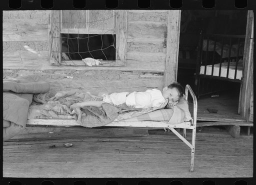 Child afflicted with tuberculosis of the spine in cast on porch of his home near Warner, Oklahoma. Tenant farm family