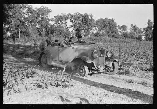 Pushing a car belonging to agricultural day laborer to start it, near Muskogee, Muskogee County, Oklahoma