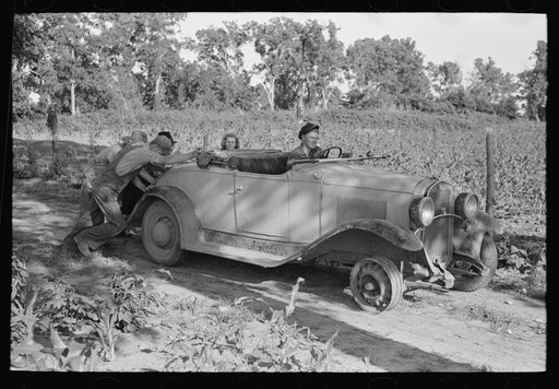 Untitled photo, possibly related to: Pushing a car belonging to agricultural day laborer to start it, near Muskogee, Muskogee County, Oklahoma