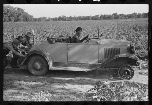Untitled photo, possibly related to: Pushing a car belonging to agricultural day laborer to start it, near Muskogee, Muskogee County, Oklahoma