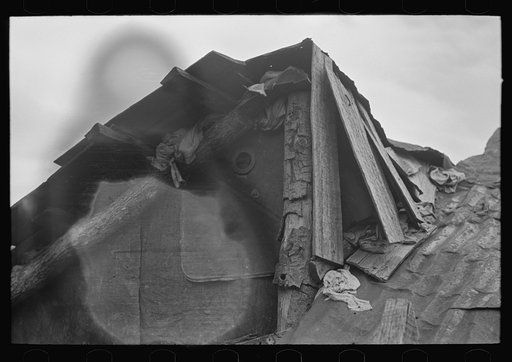 Detail of construction of roof of house of white tenant family. Notice the rags stuffed in under the shingles to keep out cold and rain. McIntosh County, Oklahoma