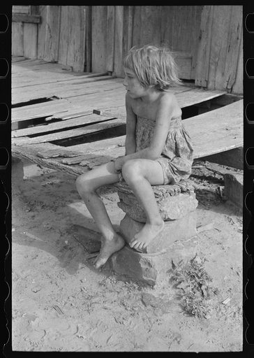 Daughter of agricultural day laborer on porch of her home, McIntosh County, Oklahoma