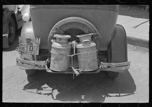 Milk cans tied on back of farm automobile, Muskogee, Oklahoma