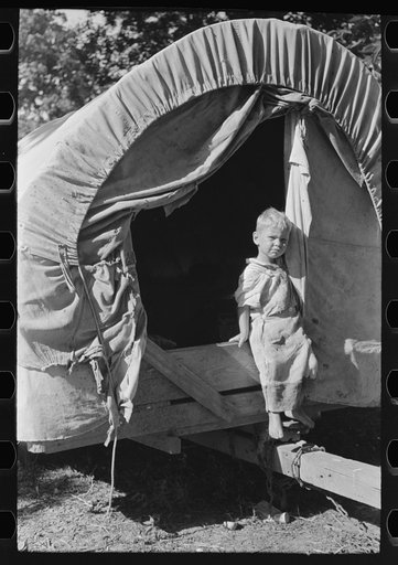 Untitled photo, possibly related to: Son of white migrant stepping from covered wagon-type trailer, Wagoner County, Oklahoma