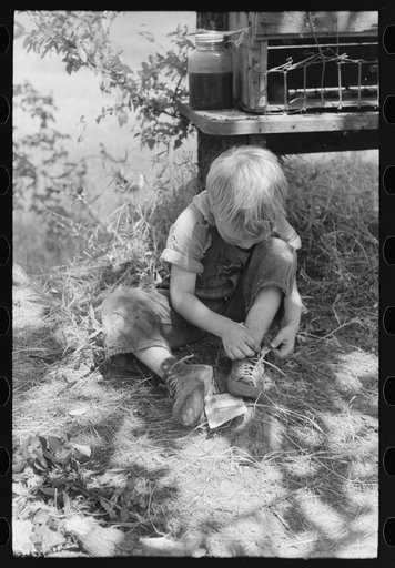 Untitled photo, possibly related to: Child of family encamped in the open after leaving the Arkansas River bottoms because of hordes of mosquitoes. This camp was near Spiro, Oklahoma