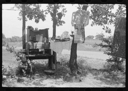 Child of family encamped in the open after leaving the Arkansas River bottoms because of hordes of mosquitoes. This camp was near Spiro, Oklahoma