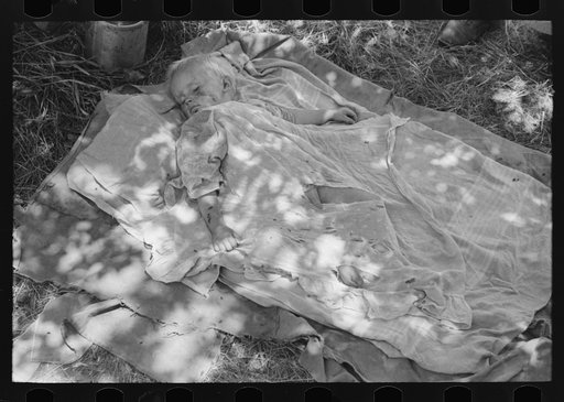 Child of family encamped by the roadside near Spiro, Oklahoma. This family is doing agricultural day labor to secure funds to continue westward. Sequoyah County, Oklahoma