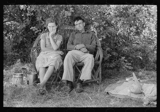 Husband and wife sitting on settee encamped by the roadside, Wagoner County, Oklahoma