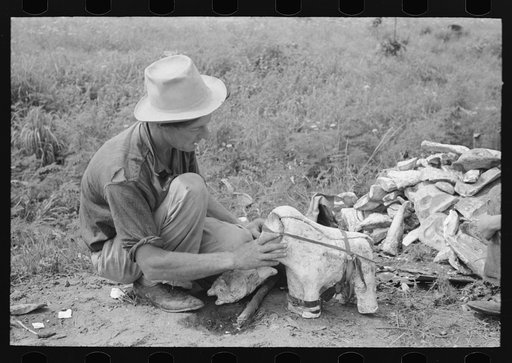 Itinerant statue maker putting together the pieces of a mold for one of his statues. He had been at one time an oil field worker. He said that the WPA (Work Projects Administration) had reduced the possibility of the man on the road getting a job. He said he believed he could farm if he could get a 