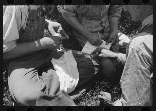 Turning in the checks received for picking up potatoes at pay office near Spiro, Oklahoma. Pickers received three cents per bushel