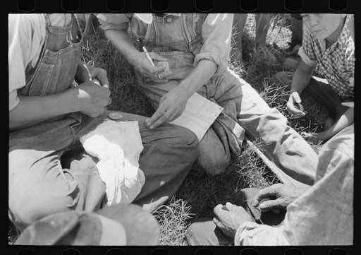 Untitled photo, possibly related to: Turning in the checks received for picking up potatoes at pay office near Spiro, Oklahoma. Pickers received three cents per bushel