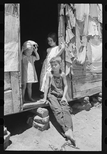 Untitled photo, possibly related to: Children of agricultural day laborer who was picking up potatoes. The father, an oil field worker, had deserted the family. The shack was near Vian, Oklahoma