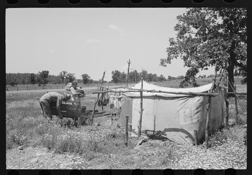 Camp of migratory workers who move along the road pushing their belongings in a cart, camped near Vian, Sequoyah County, Oklahoma