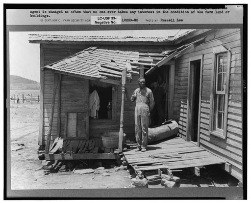 Negro tenant farmer on his front porch. This farm is owned by an out-of-state woman and has been rented by this family of Negroes for eleven years. The Negro man says that the agent is changed so often that no one ever takes any interest in the condition of the land or buildings. South of Muskogee, 