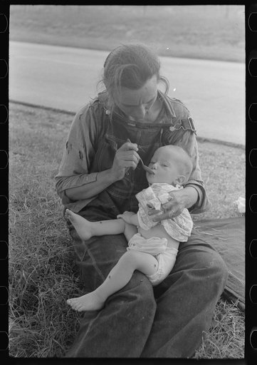 Migrant mother feeding her baby while the family was stopped by the roadside for lunch, east of Fort Gibson, Muskogee County, Oklahoma