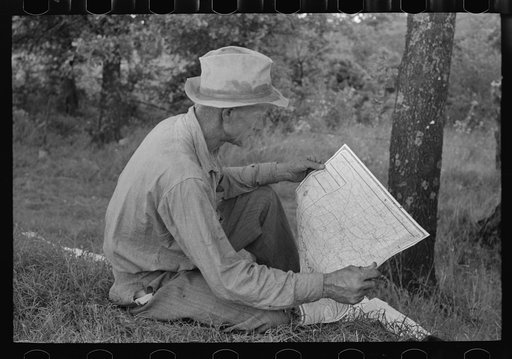 Untitled photo, possibly related to: White migrant agricultural worker from Texas studying the map while stopped for lunch on the roadside east of Fort Gibson, Oklahoma