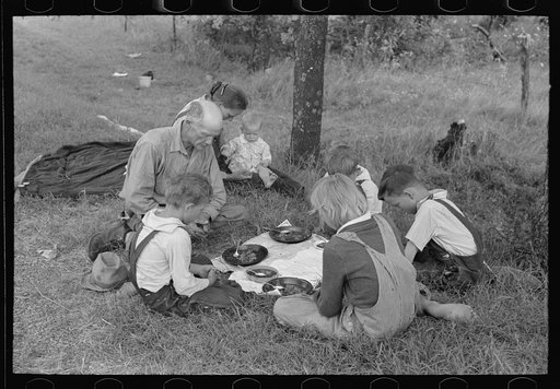 White migrant family saying grace before noonday meal by the side of the road east of Fort Gibson, Muskogee County, Oklahoma