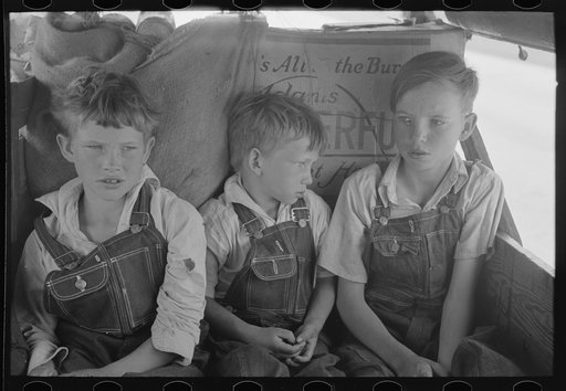 White migrant children sitting in back seat of family car east of Fort Gibson, Muskogee County, Oklahoma