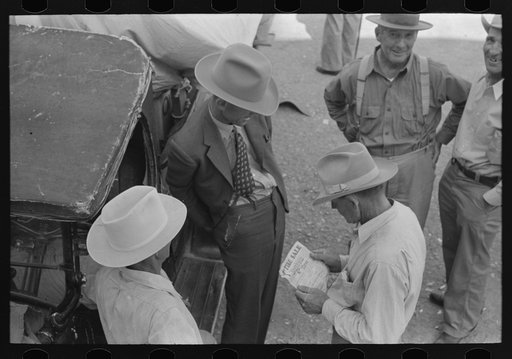 Untitled photo, possibly related to: Farmers talking and looking at tire sale handbill, Weatherford, Texas