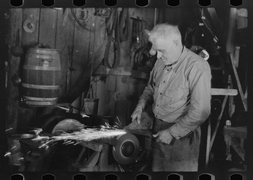 Blacksmith sharpening cultivator point south of Marshall, Texas