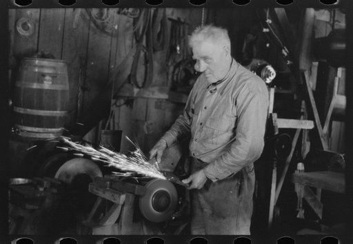 Untitled photo, possibly related to: Blacksmith sharpening cultivator point south of Marshall, Texas