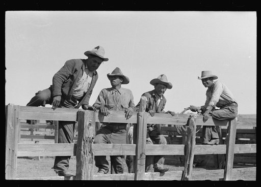 Untitled photo, possibly related to: Cowboys sitting on corral fence. Roundup near Marfa, Texas