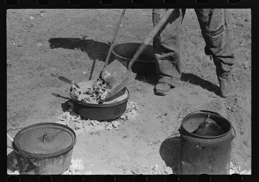 Untitled photo, possibly related to: Placing coals on lid of dutch oven for baking bread. Roundup near Marfa, Texas