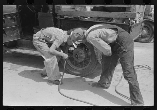 Migrants on the road checking tires at filling station near Henrietta [i.e., Henryetta,] Oklahoma