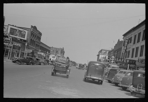 Main street of Muskogee, Oklahoma with migrants' car passing down the middle of it