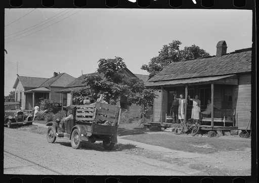 Migrant's car stopped along the road, with part of migrant family in rear seat of truck, under a tree to await the rain's passing, near Muskogee, Oklahoma