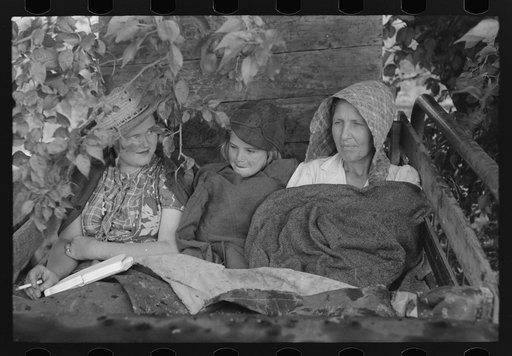 Migrant's car stopped along the road, with part of migrant family in rear seat of truck, under a tree to await the rain's passing, near Muskogee, Oklahoma
