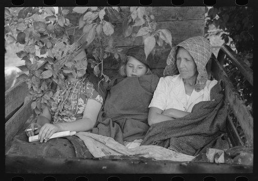 Untitled photo, possibly related to: Migrant's car stopped along the road, with part of migrant family in rear seat of truck, under a tree to await the rain's passing, near Muskogee, Oklahoma