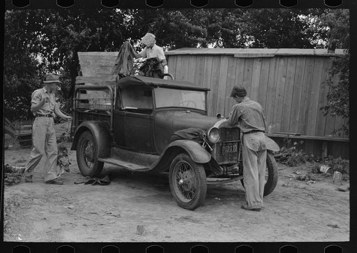 Untitled photo, possibly related to: Migrant boy getting ready to crank his car, Muskogee, Oklahoma