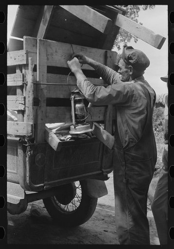 Tying lantern onto the back of improvised truck which will travel to California near Muskogee, Oklahoma