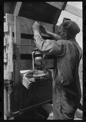 Tying the lantern onto the back of improvised truck which will travel to California near Muskogee, Oklahoma