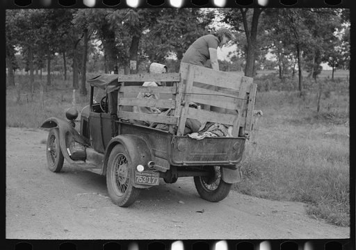 Untitled photo, possibly related to: Migrant getting out of car with pail to get some water. Encamped along roadside near Henrietta [i.e., Henryetta,] Oklahoma