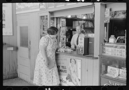 Tobacco stand keeper talking with woman. Streetcar terminal, Oklahoma City, Oklahoma