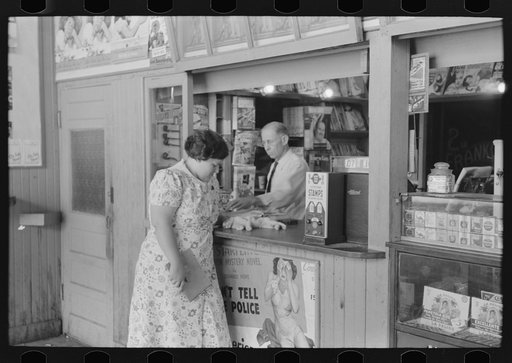 Untitled photo, possibly related to: Tobacco stand keeper talking with woman. Streetcar terminal, Oklahoma City, Oklahoma