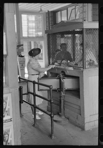Woman buying ticket at gate. Streetcar terminal, Oklahoma City, Oklahoma