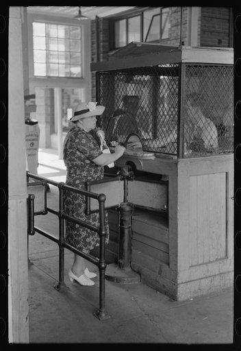 Woman buying ticket at gate. Streetcar terminal, Oklahoma City, Oklahoma