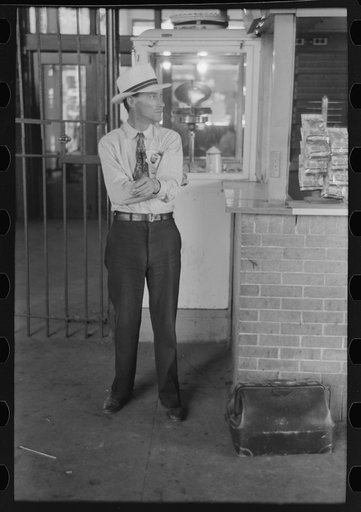 Man with luggage waiting for streetcar. Terminal, Oklahoma City, Oklahoma