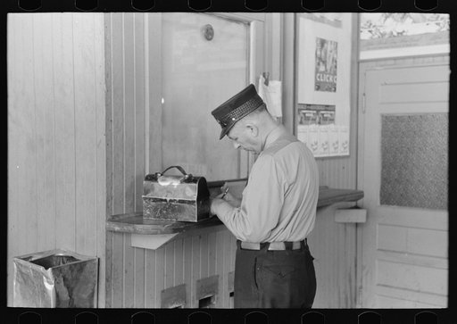 Motorman with lunch basket making out reports. Streetcar terminal, Oklahoma City, Oklahoma
