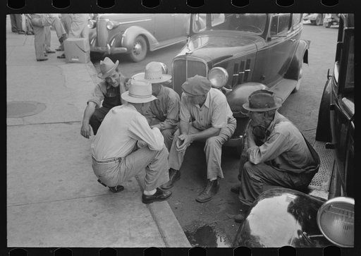 Group of men talking in street of Muskogee, Oklahoma