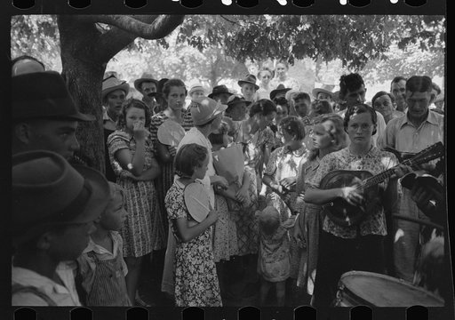 Group of people assembled under tree to listen to revival rally on Saturday afternoon, Tahlequah, Oklahoma