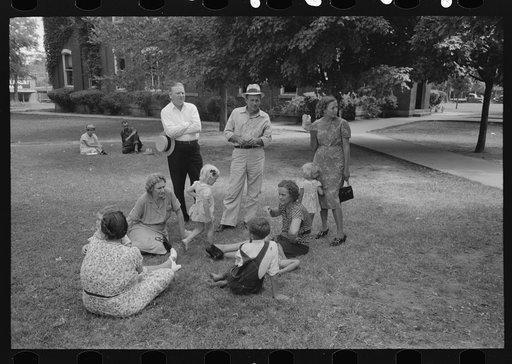 Group of people sitting in square in front of courthouse, Tahlequah, Oklahoma